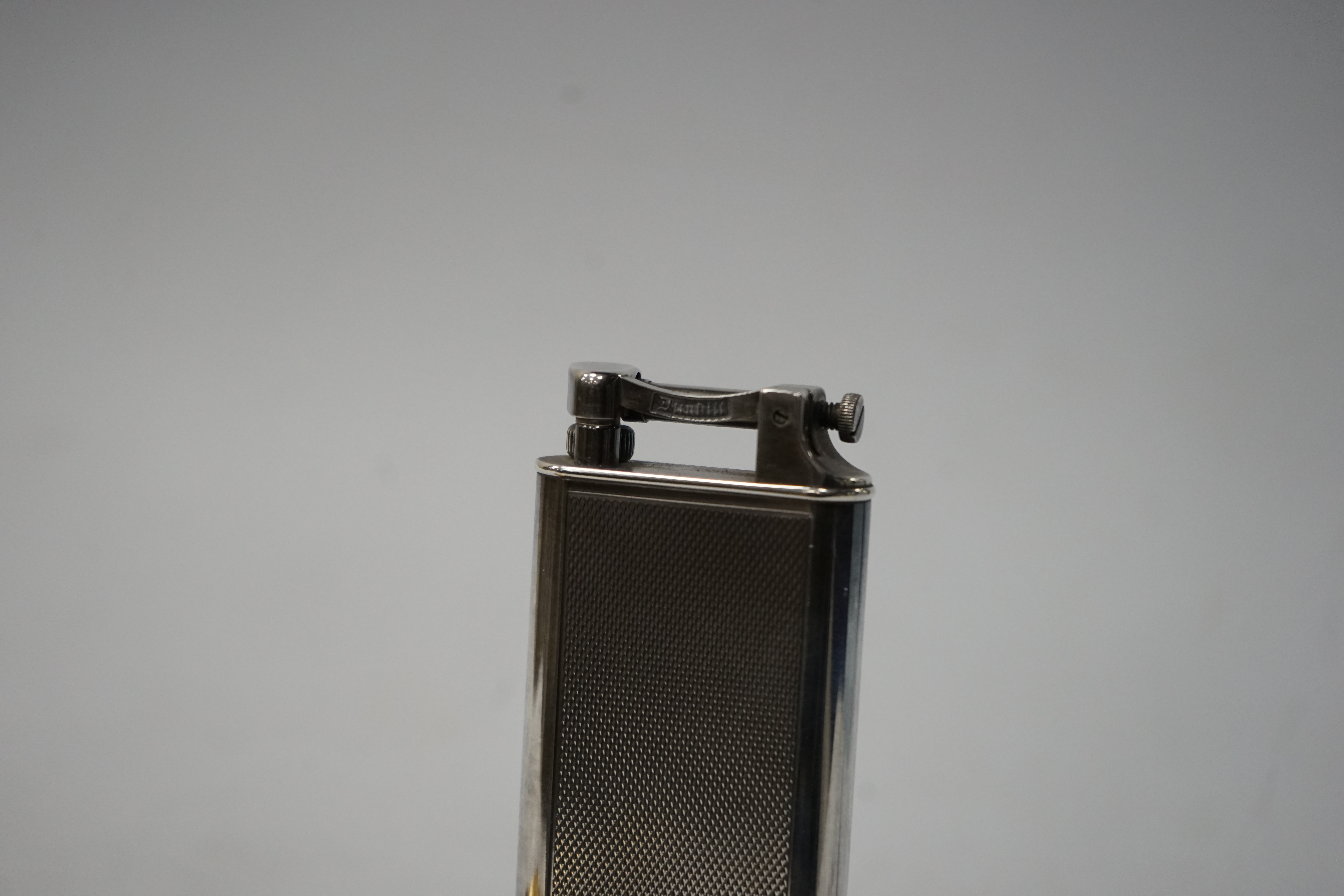 Two Dunhill lighters to include a plated table lighter, largest 10cm high. Condition - fair to good, not working